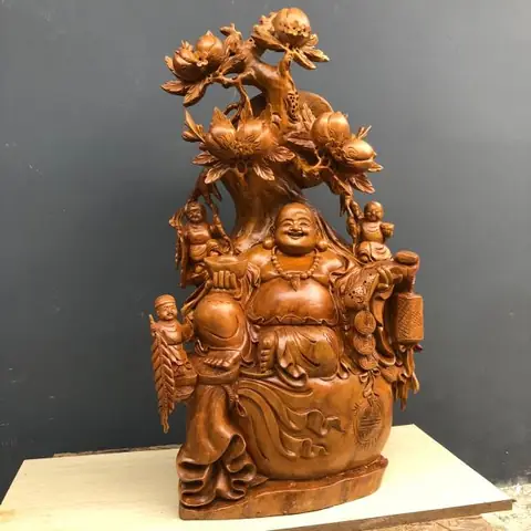 Tác Phẩm Phật Di Lặc Xá Xị Ngồi Gốc Đào- Phật Di Lặc Ngồi Gốc Đào Với Tự Thế Tự Tại, Cửu Phúc Vậy Xung Quanh Mang Ý Nghĩa Sự Trường Thọ Vĩnh Viễn, Từ Cửu Trong Từ Vĩnh Cữu Trường Tồn Theo Thời Gian. Tượng Cao 1m30 Rộng 1m25 Sâu 45cm, Chế Tác Trên Nền Chất Gỗ Xá Xị Nguyên Gốc, Đường Nét Tự Nhiên Tạo Nên Khác Biệt Của Tượng Phật.